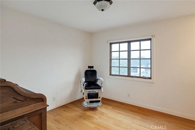 living area featuring light wood-type flooring and baseboards