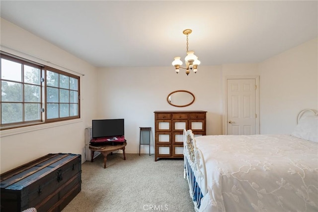 carpeted bedroom featuring a notable chandelier