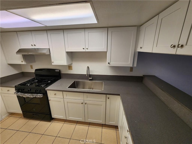 kitchen featuring under cabinet range hood, a sink, white cabinetry, black gas stove, and dark countertops