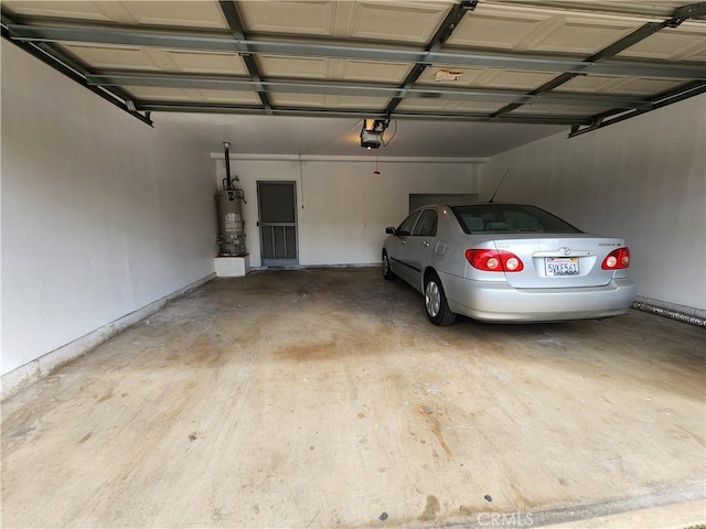 garage with a garage door opener and strapped water heater