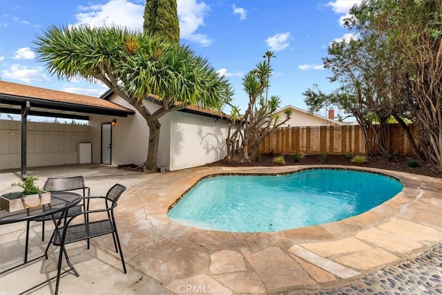 view of swimming pool with fence, a fenced in pool, and a patio