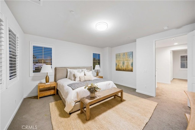 bedroom featuring light carpet and baseboards