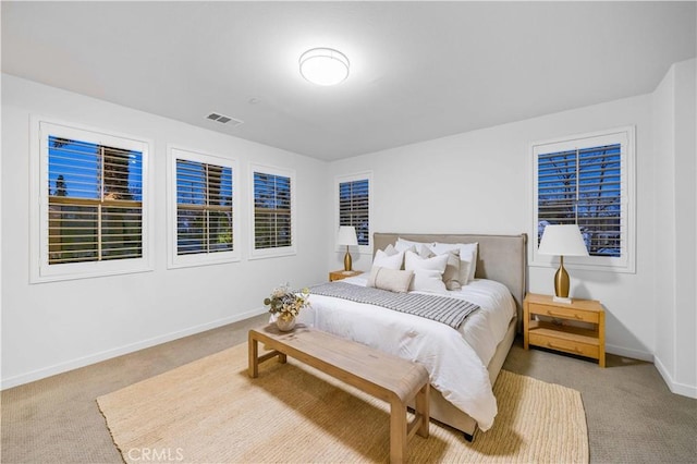 bedroom with carpet, visible vents, and baseboards