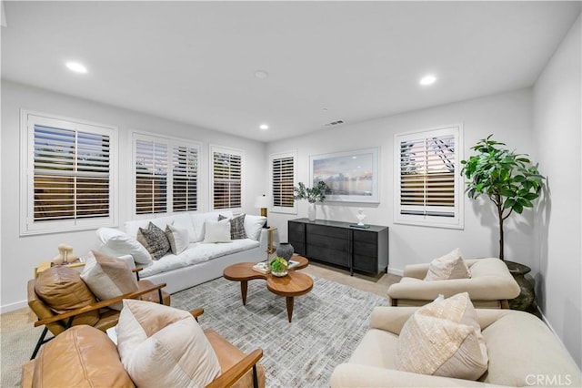 carpeted living area with visible vents, baseboards, and recessed lighting