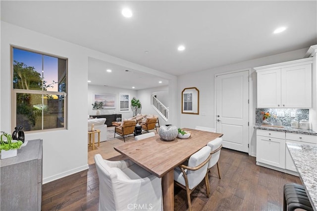 dining area featuring stairway, dark wood finished floors, and recessed lighting