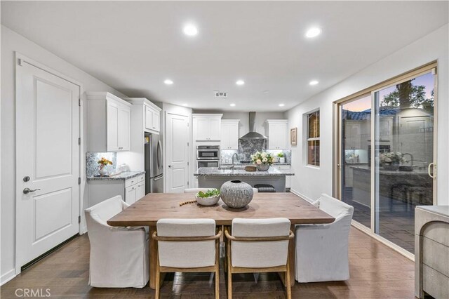 dining area featuring dark wood-type flooring, recessed lighting, and visible vents