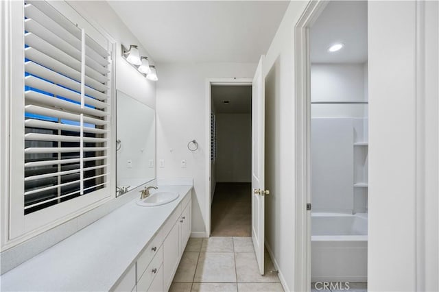 bathroom with tile patterned flooring, vanity, and baseboards