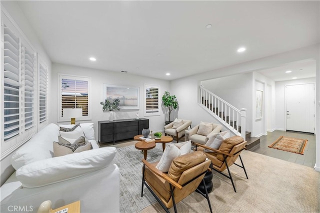 living area with stairs, wood finished floors, and recessed lighting