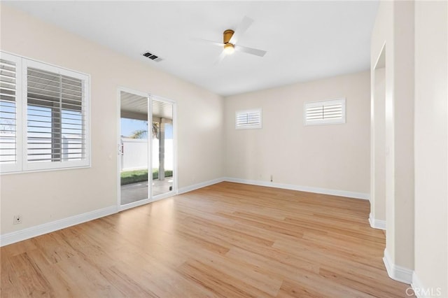 unfurnished room featuring ceiling fan, light wood finished floors, and baseboards