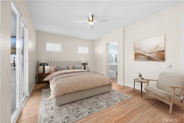 bedroom featuring a ceiling fan, light wood-type flooring, baseboards, and ensuite bathroom