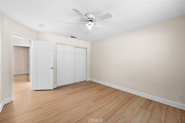 unfurnished bedroom with light wood-type flooring, visible vents, and baseboards