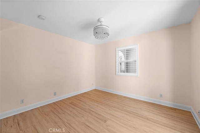 unfurnished room with light wood-style floors and baseboards