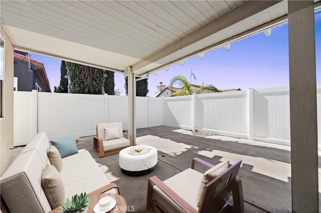 view of patio with an outdoor living space with a fire pit and a fenced backyard