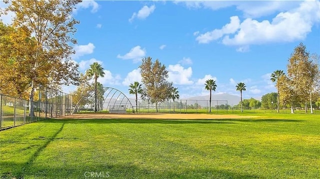 view of property's community featuring a yard and fence