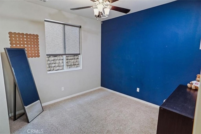 unfurnished bedroom featuring a ceiling fan, carpet flooring, and baseboards