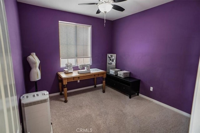 office space featuring carpet floors, ceiling fan, and baseboards