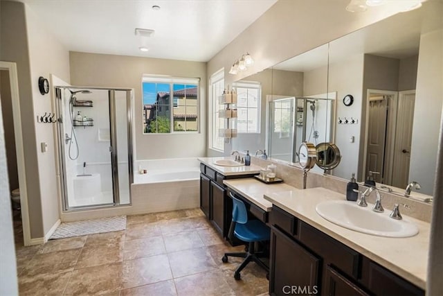 full bath featuring a stall shower, double vanity, a sink, and a bath