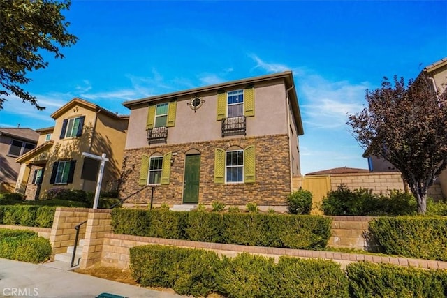 view of front of house featuring stone siding and stucco siding