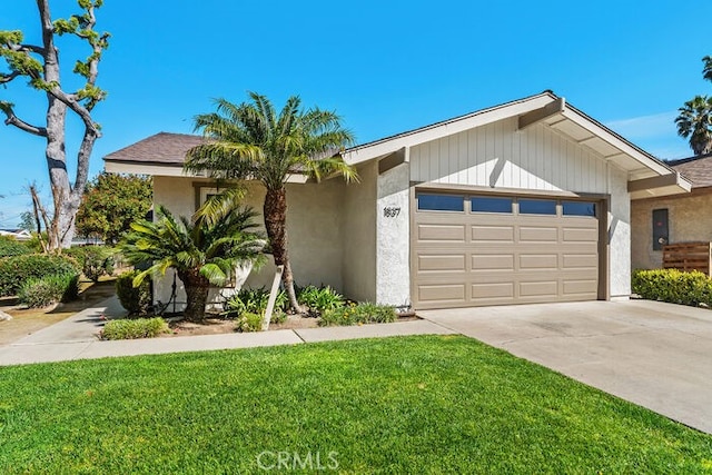 ranch-style house featuring a garage, driveway, a front yard, and stucco siding