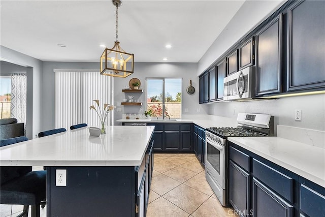 kitchen with stainless steel appliances, a sink, hanging light fixtures, open shelves, and a kitchen bar