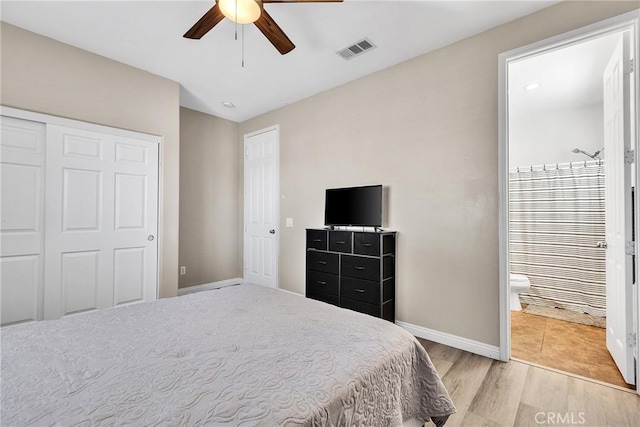 bedroom featuring baseboards, visible vents, a ceiling fan, connected bathroom, and light wood-type flooring