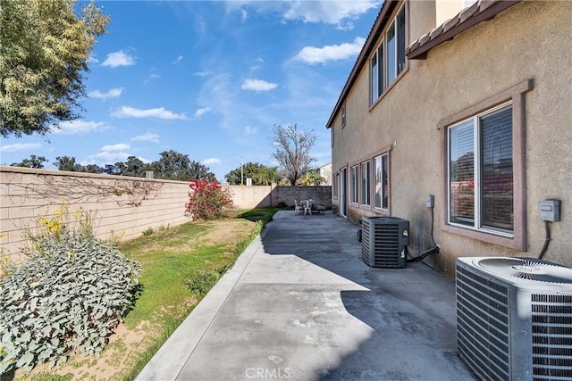 view of yard with a patio area, a fenced backyard, and central air condition unit