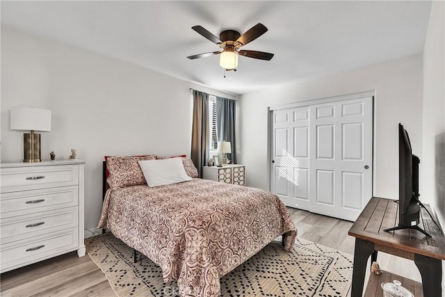 bedroom with a ceiling fan, light wood-type flooring, and a closet