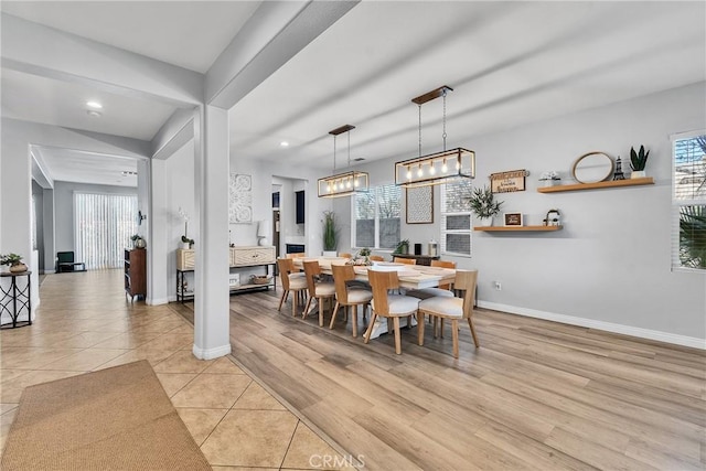 dining space with light wood finished floors, baseboards, and recessed lighting