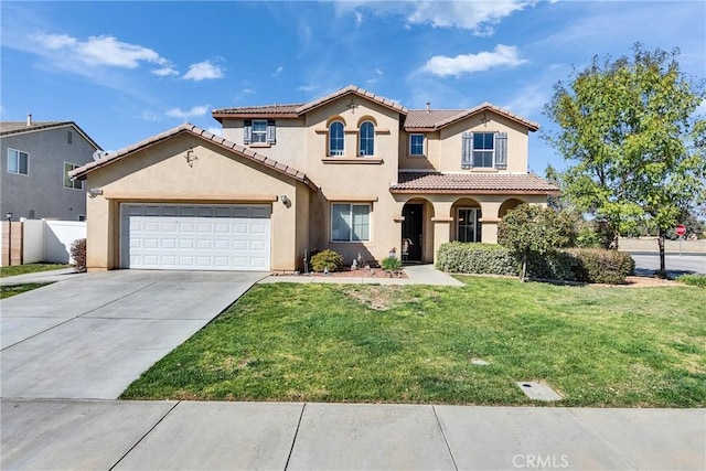 mediterranean / spanish house featuring driveway, an attached garage, fence, a front lawn, and stucco siding