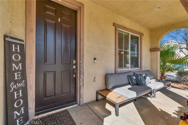 entrance to property featuring stucco siding