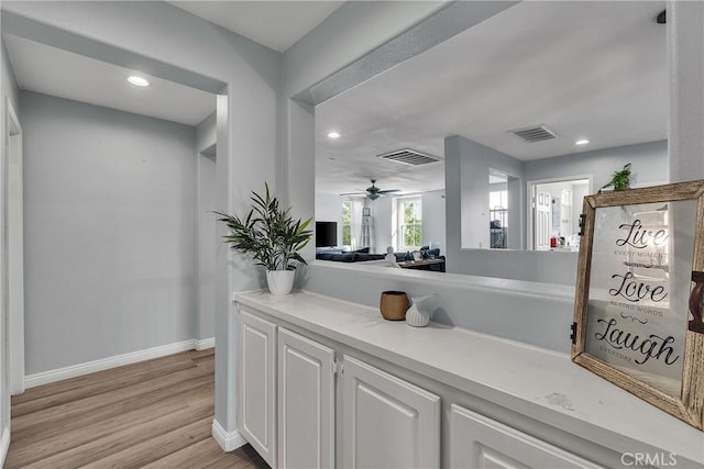 interior space featuring light wood-type flooring, visible vents, baseboards, and recessed lighting