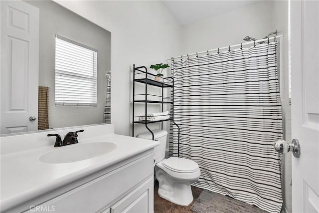 bathroom featuring vanity, toilet, and a shower with curtain