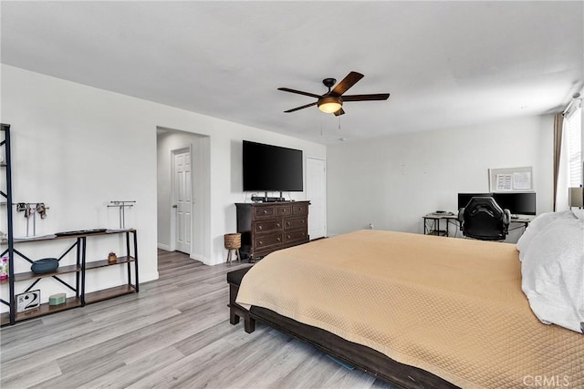 bedroom featuring ceiling fan, light wood-type flooring, and baseboards