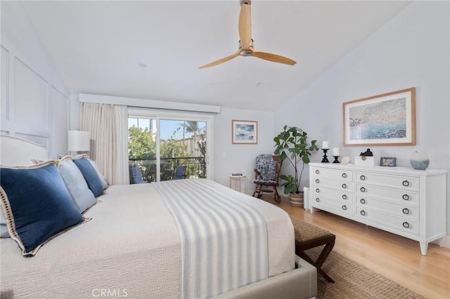 bedroom featuring access to exterior, a ceiling fan, light wood-style floors, and lofted ceiling