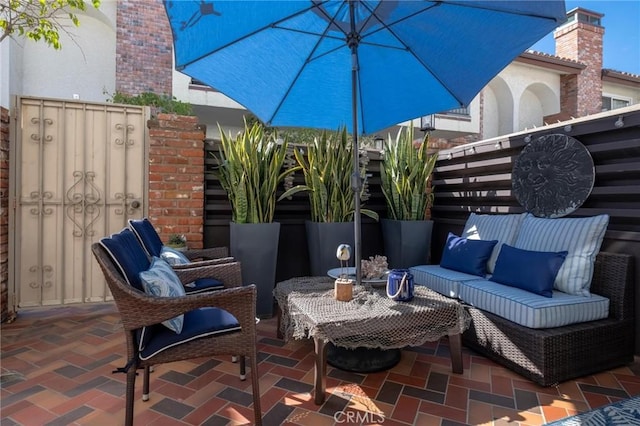 view of patio / terrace featuring outdoor lounge area and fence