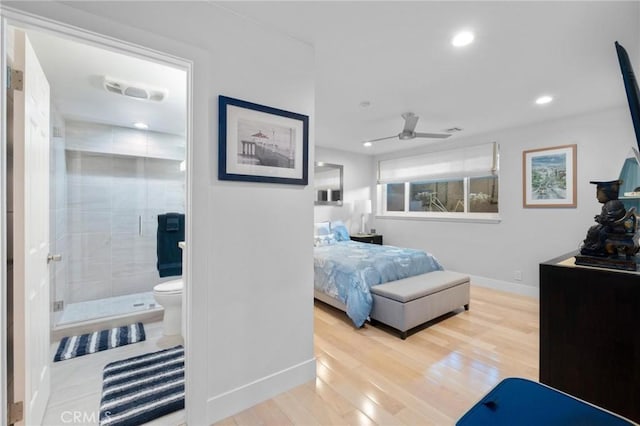 bedroom featuring recessed lighting, wood finished floors, baseboards, and ensuite bathroom