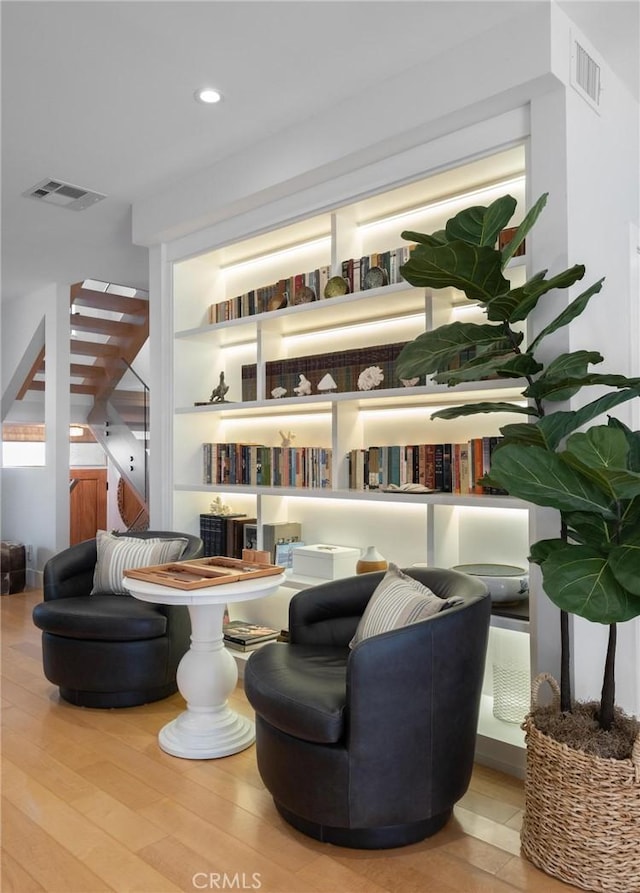 sitting room with recessed lighting, visible vents, and wood finished floors