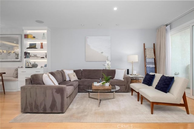 living room with recessed lighting and light wood-type flooring