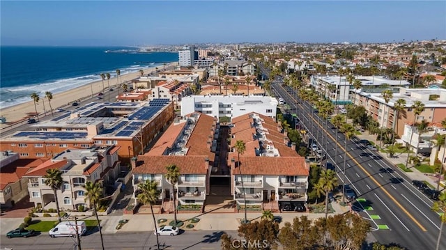 drone / aerial view with a beach view and a water view