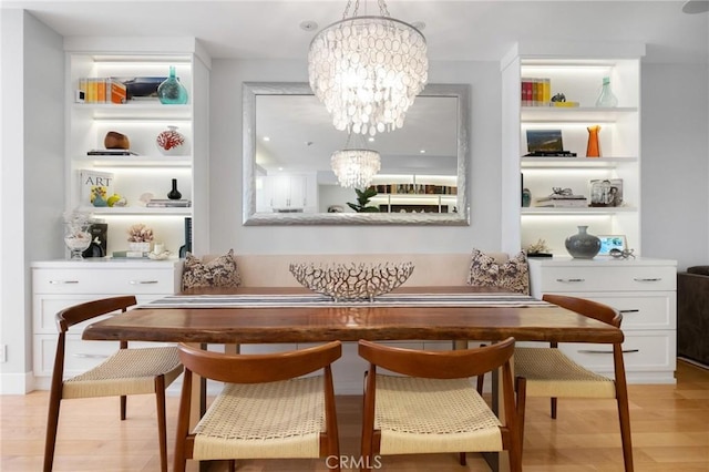 dining room featuring a chandelier and light wood-type flooring