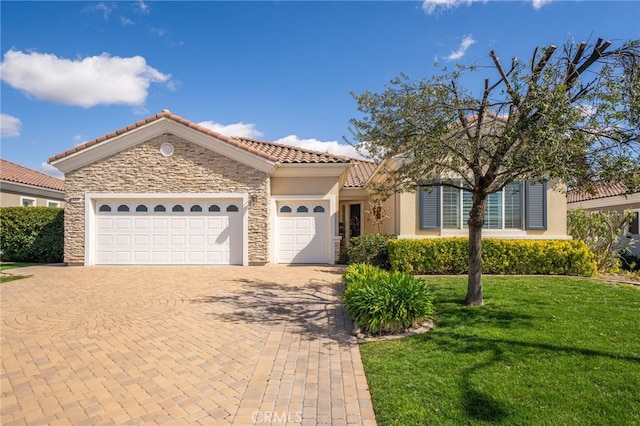 view of front facade featuring decorative driveway, stucco siding, an attached garage, stone siding, and a front lawn