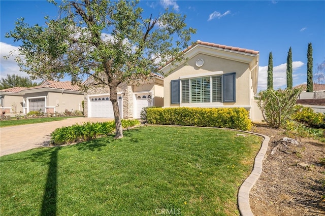 mediterranean / spanish house featuring stucco siding, a front yard, a garage, driveway, and a tiled roof