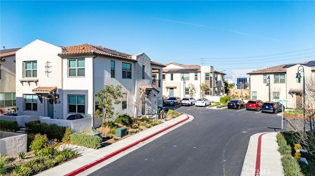 view of street featuring a residential view, curbs, and sidewalks