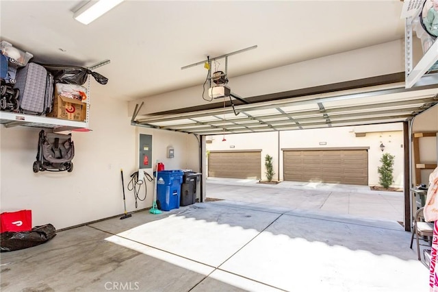 garage with a garage door opener and electric panel