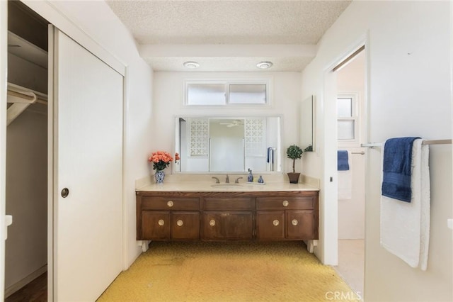 bathroom with a textured ceiling and vanity