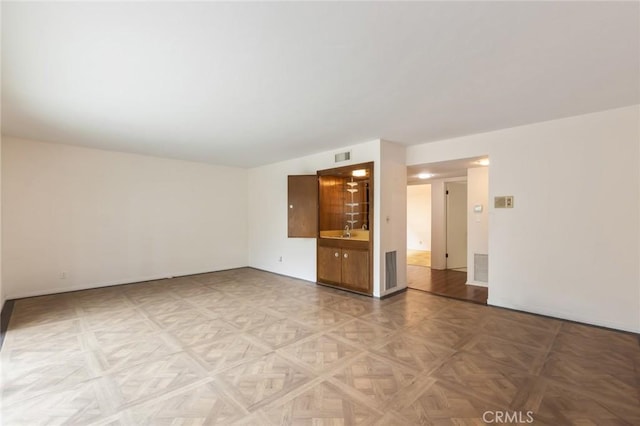 empty room featuring visible vents and a sink