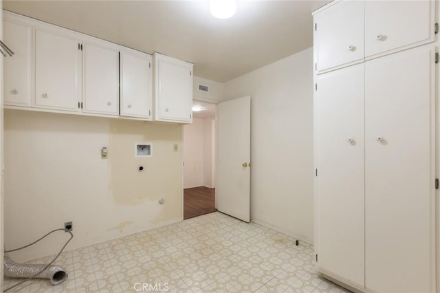 laundry area with gas dryer hookup, visible vents, cabinet space, light floors, and electric dryer hookup