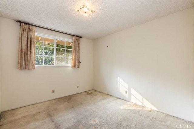 empty room featuring carpet floors and a textured ceiling