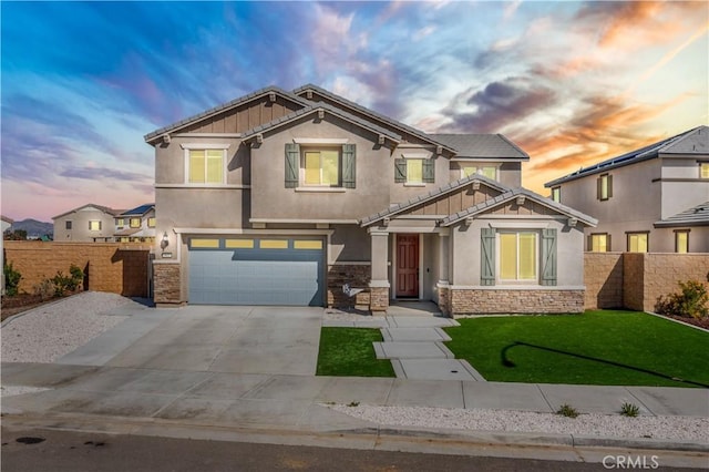 craftsman house with a garage, fence, stone siding, concrete driveway, and stucco siding