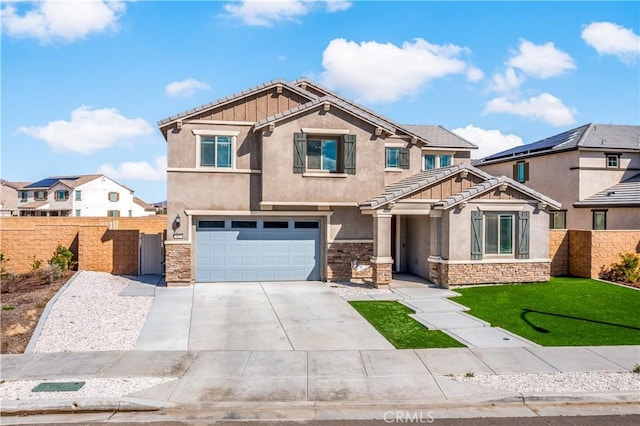 craftsman house with a garage, concrete driveway, stone siding, fence, and stucco siding